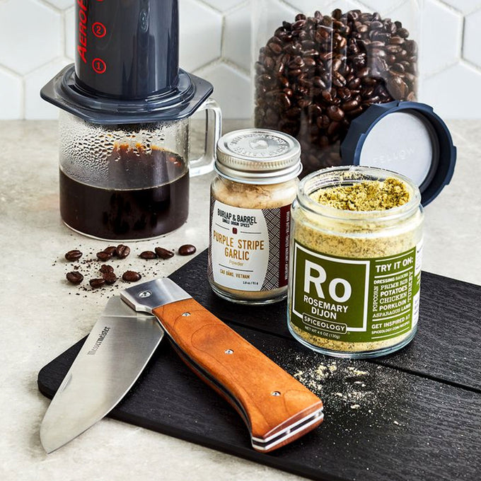 Knife, spices, and coffee-making equipment on a countertop