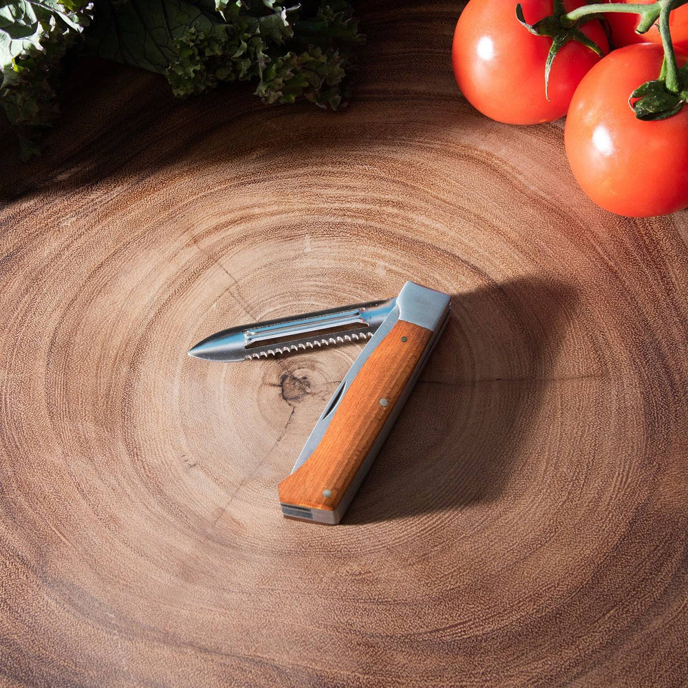 Messermeister Adventure Chef maple folding peeler and parer used outdoors while camping, hiking, or preparing meals in nature.
