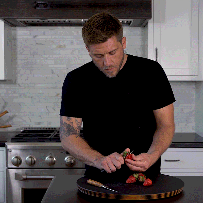 Chef  Adam Glick demonstrating how to use a paring knife for precise garnishing and trimming on strawberries