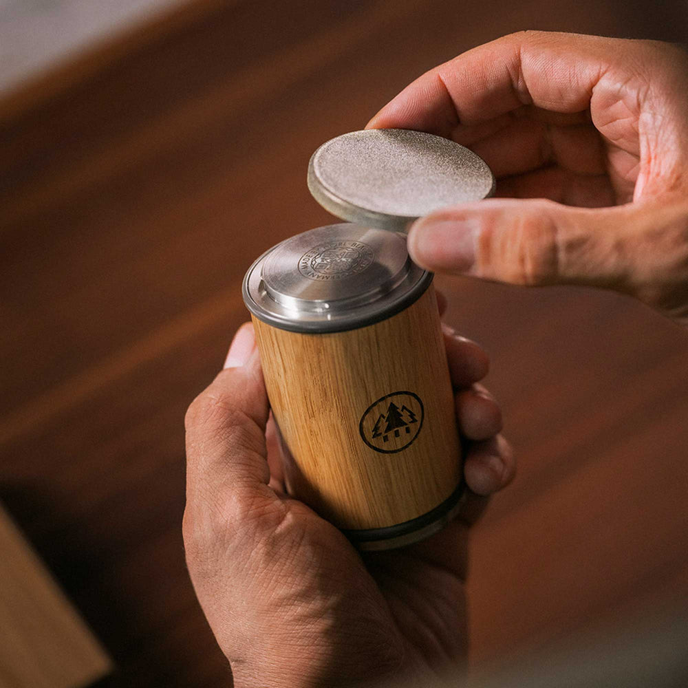 Hands changing the sharpening disc on a Horl 3 Oak Sharpener