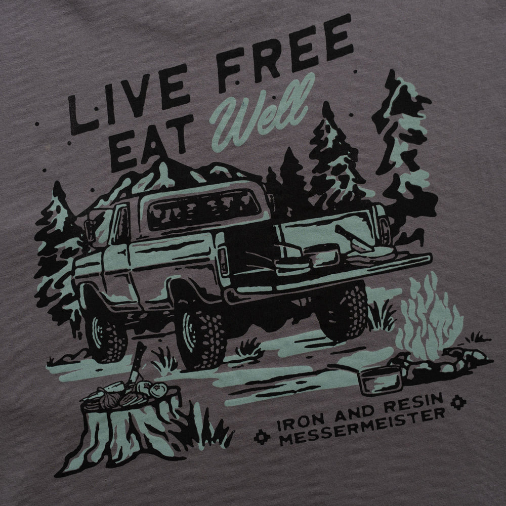 Messermeister and Iron & Resin T-shirt design with a truck, trees, and 'Live Free Eat Well' text on a dark background.