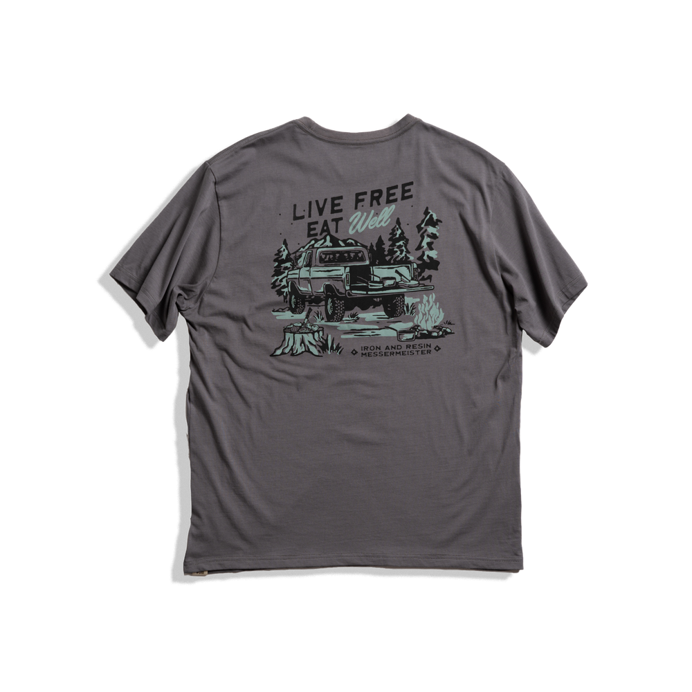Messermeister x INR 4X4 Pocket Tee - Charcoal - 100% Organic Cotton with "live well, eat free", a truck and some trees on a plain background