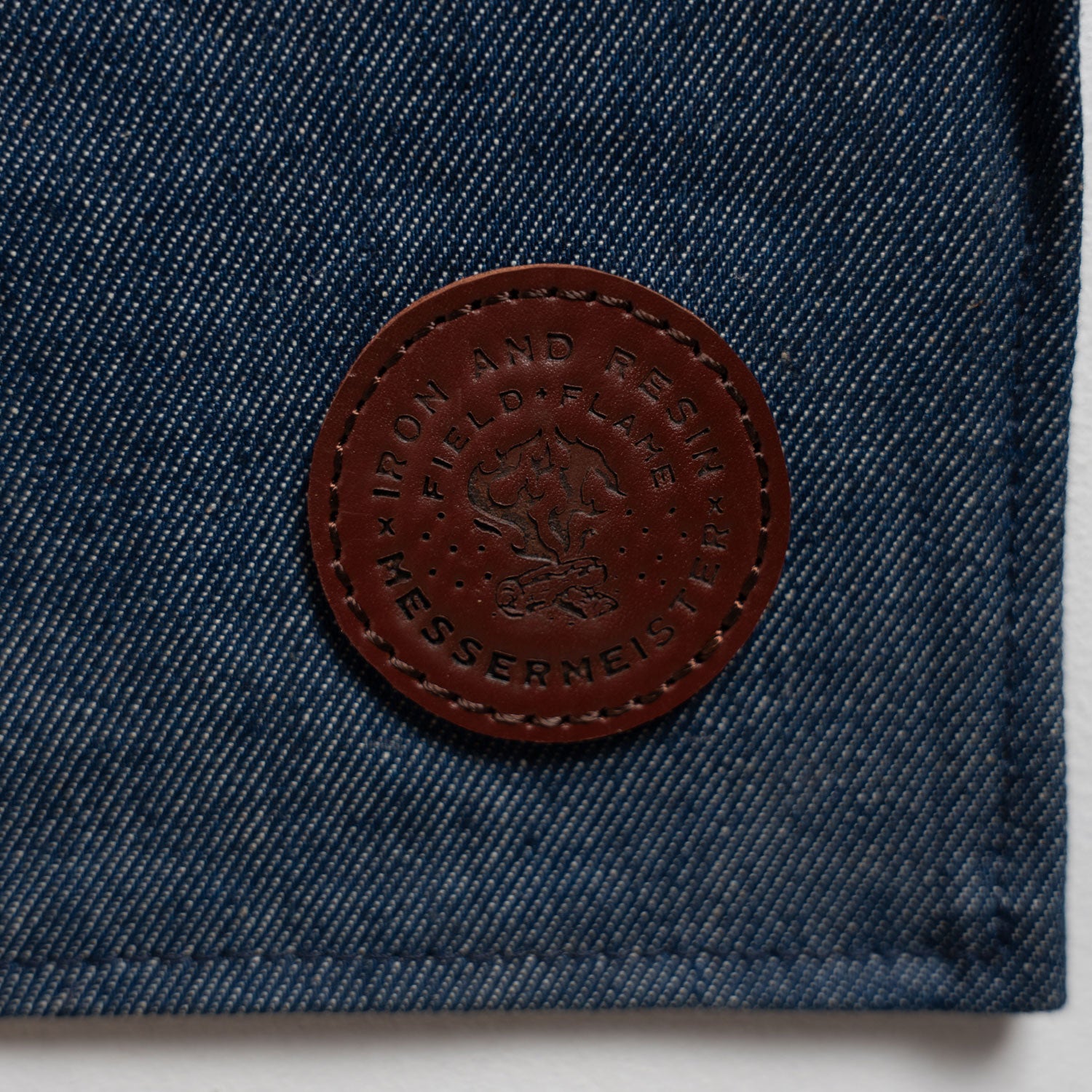 close up on the leather iron and resin / messermeister / field and flame logo