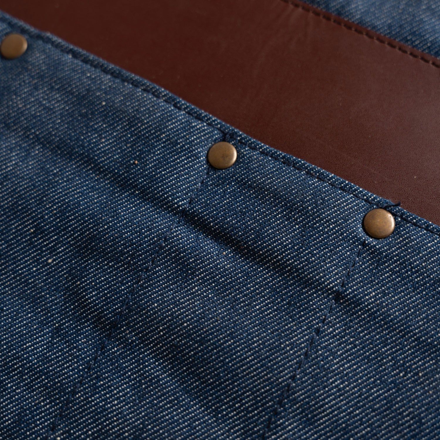 close up on brass rivets and leather strip