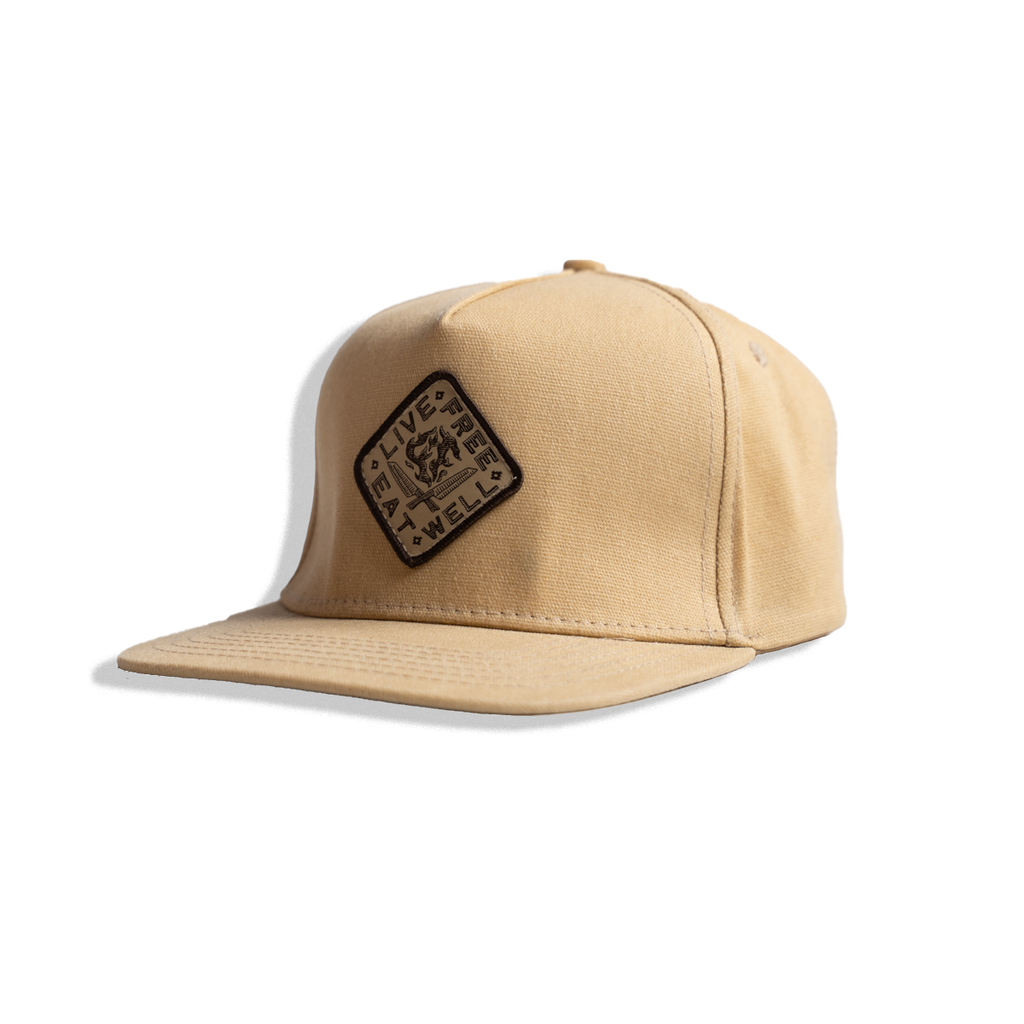 Beige INR and Messermeister cap with a logo patch