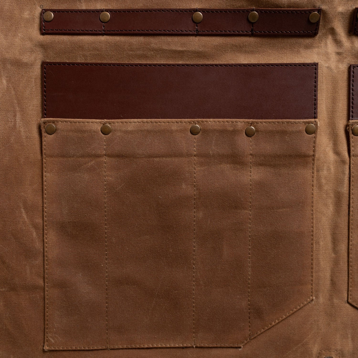 close up on the knife pockets on the apron/roll