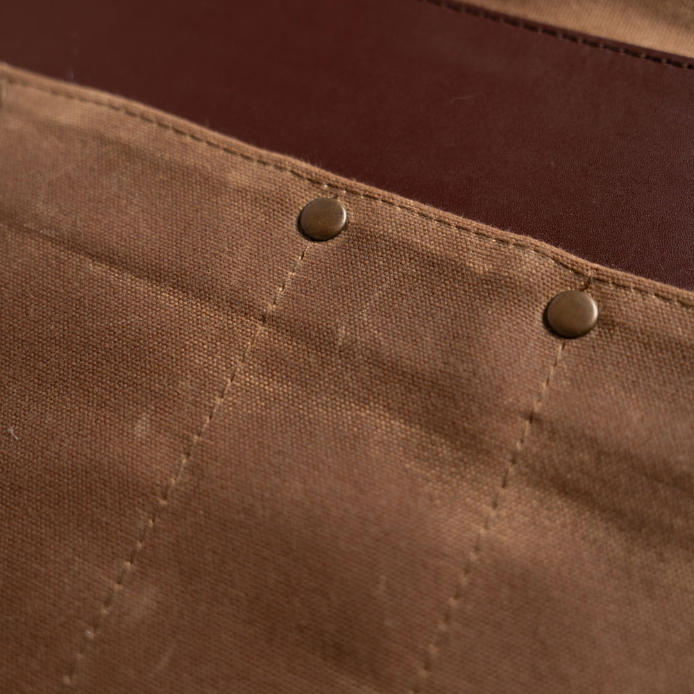close up on brass rivets and leather strip
