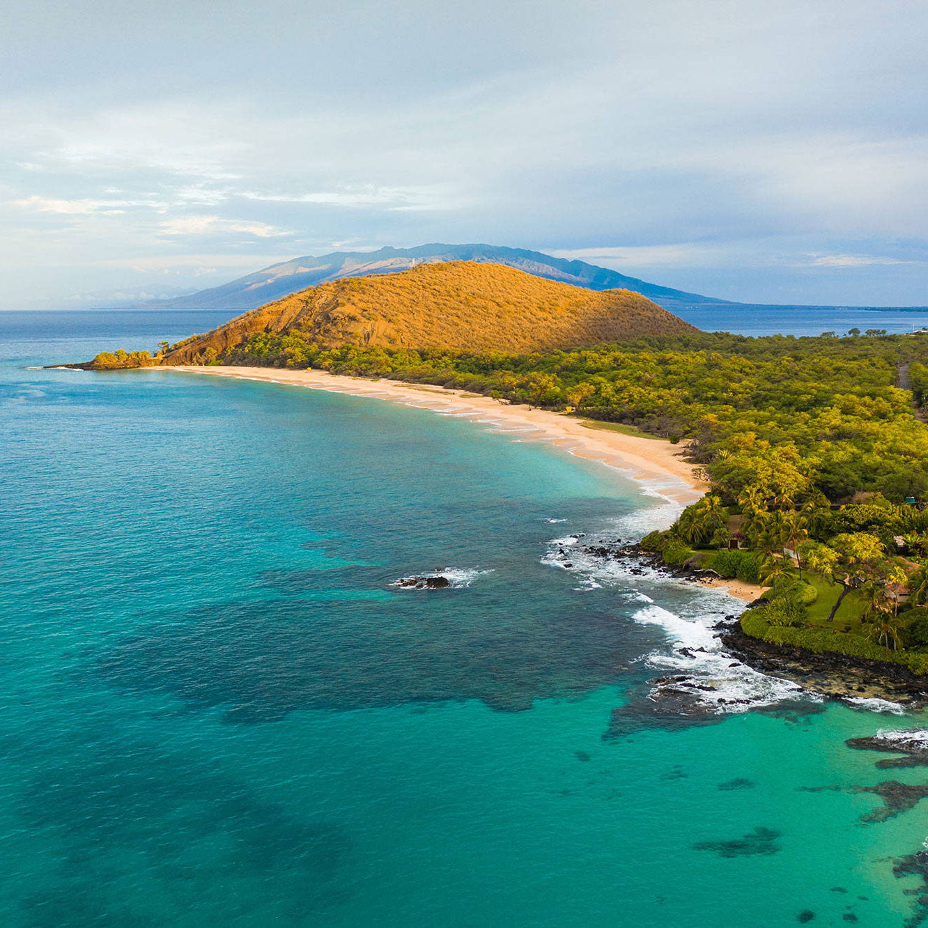 Aerial view of Maui with turquoise waters and sandy beach.