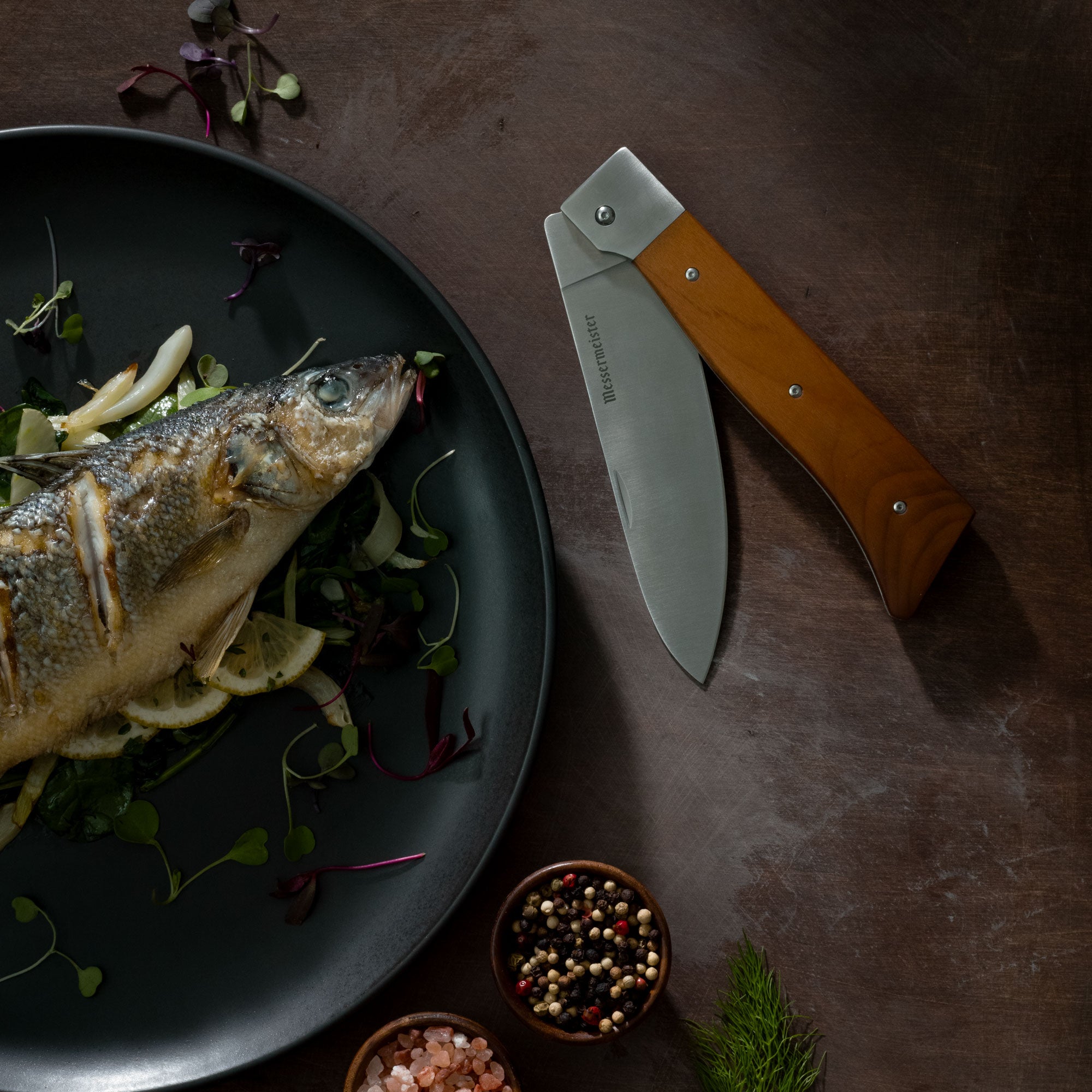 Messermeister Adventure Chef Folding Chef Knife pictured with Cooked Dinner on Dark Surface