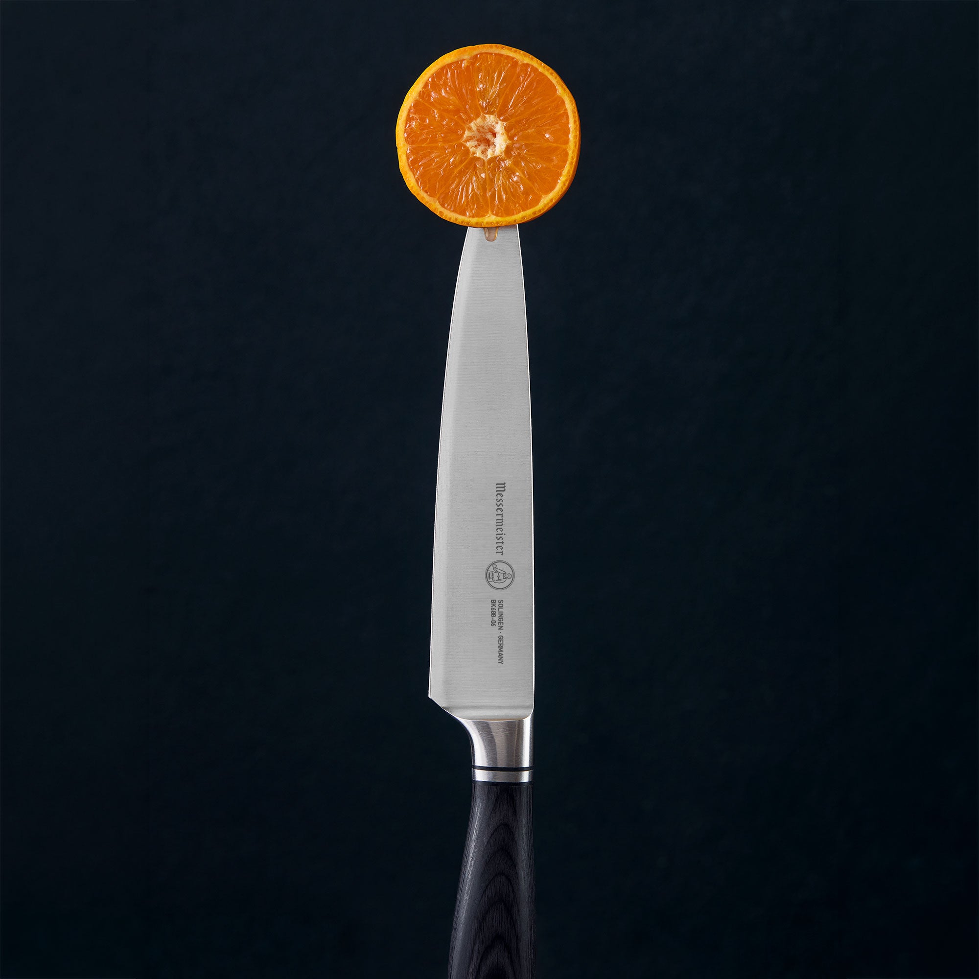 Messermeister Blacksmith Utility Knife piercing Sliced Citrus with juices dripping
