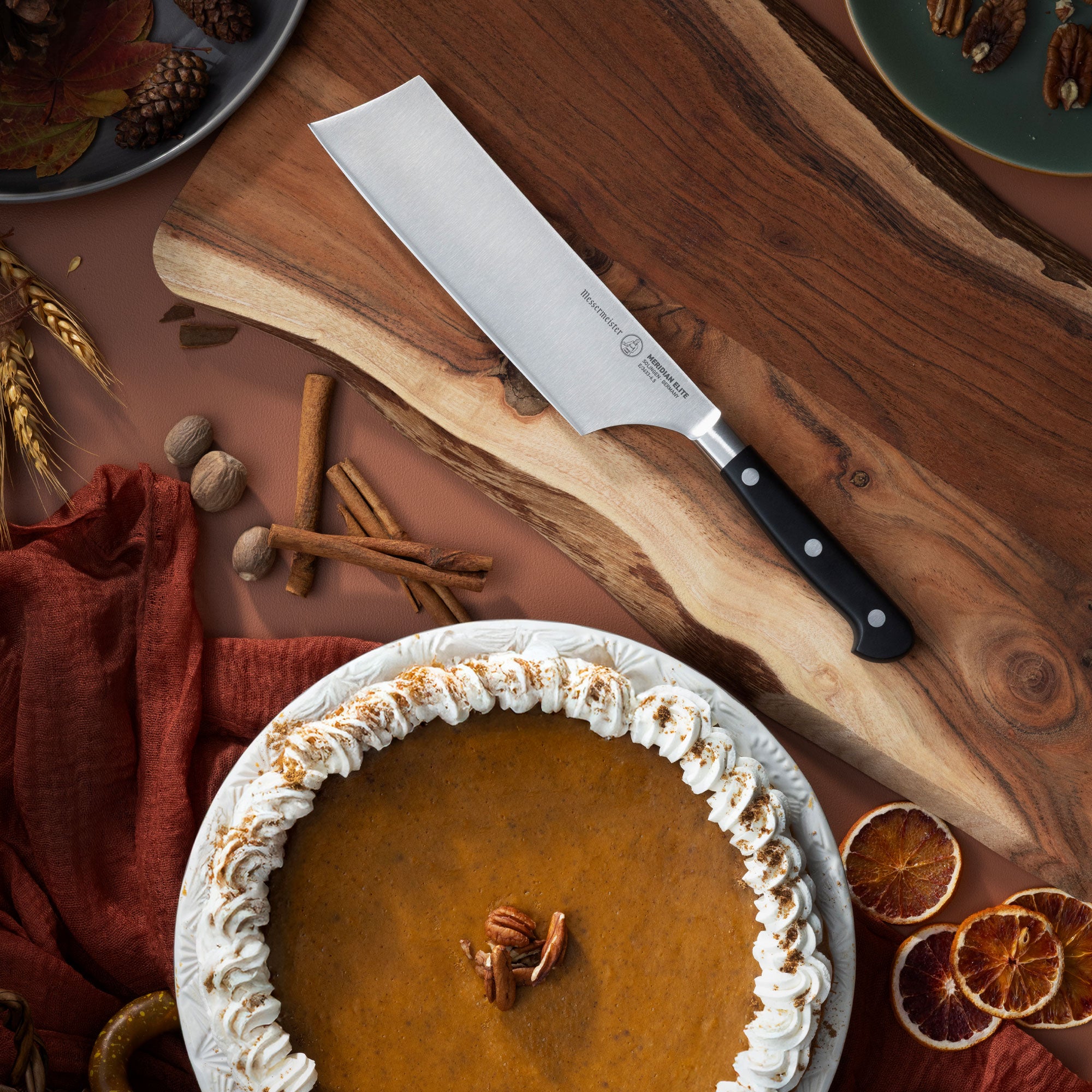 Messermeister Meridian Nakiri on Cutting Board with Pumpkin Pie and Fall Decor