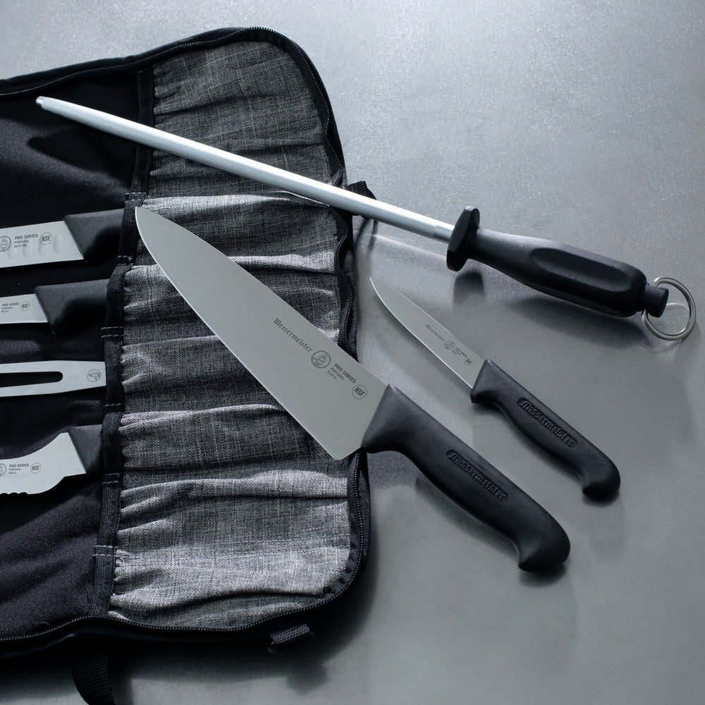Messermeister Pro Series Chef and Paring Knife on a Messermeister Preservation Knife Luggage and a Messermeister Sharpening Steel on a Stainless Steel Prep Kitchen Counter