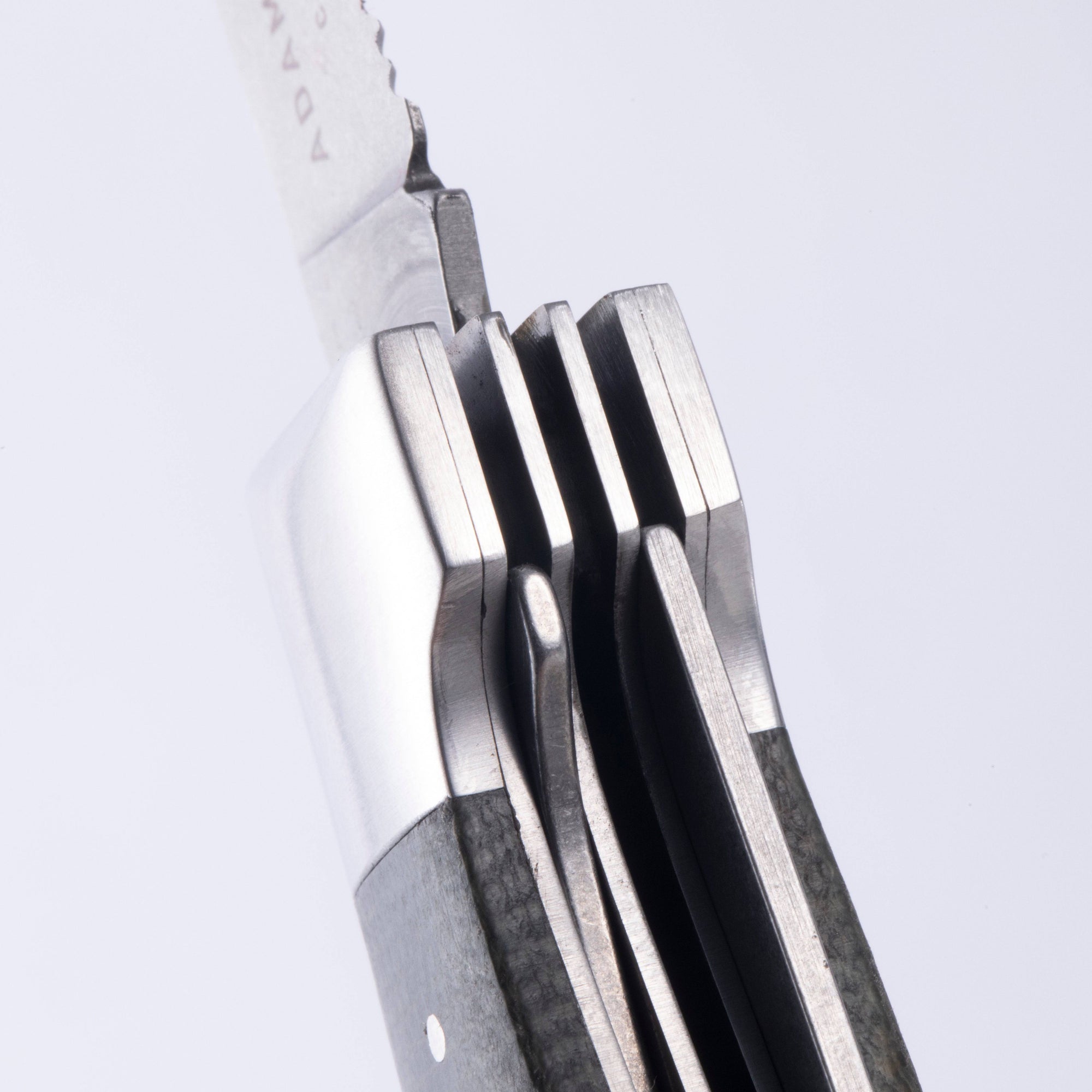 A close up view of the locking mechanism in the handle of the Messermeister Adventure Chef Linen Folding Camp Utensil.
