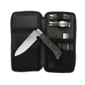 Messermeister Adventure Chef Linen Summit 6 Piece set showing the 6 inch folding Chef's Knife removed and laying on top of the open zippered carrying case with the folding utensil, folding peeler and parer, folding fillet knife and faux wood cutting board tucked inside.
