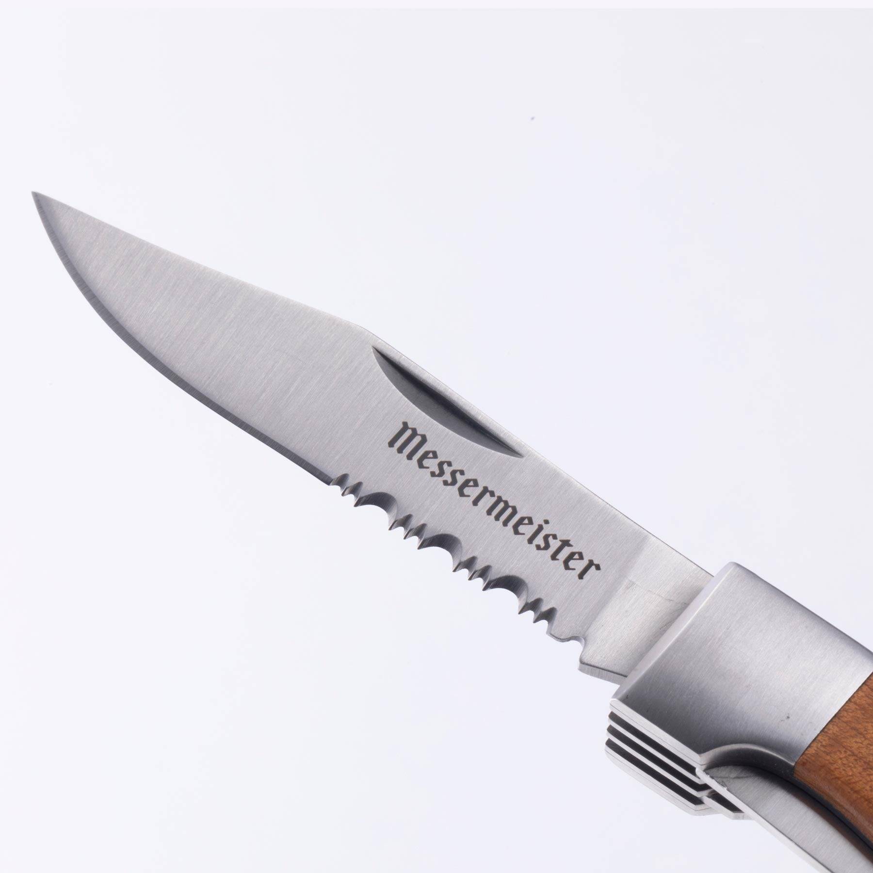 A close up view of the steak knife on the Messermeister Adventure Chef Maple Folding Camp Utensil.