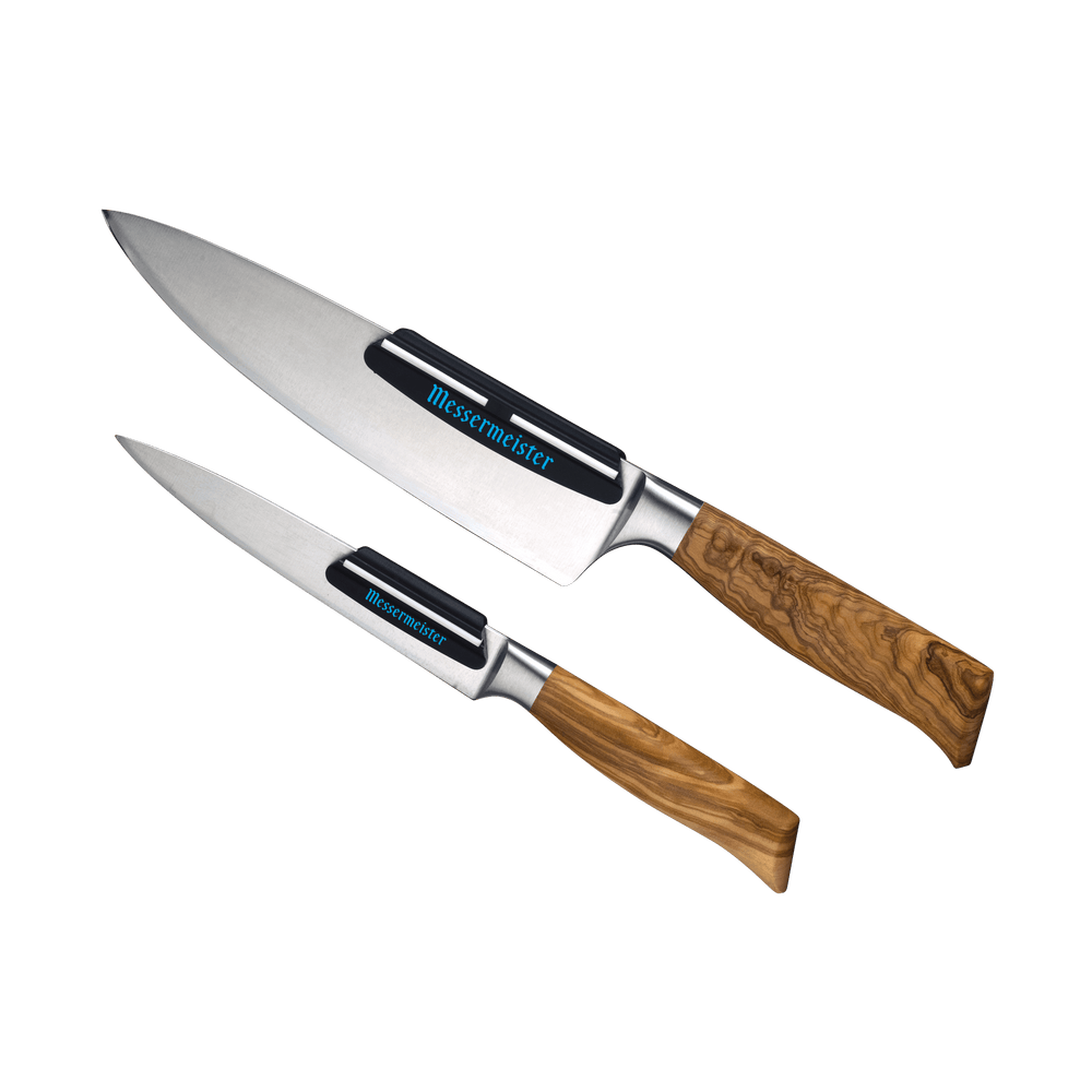 Two knives with wooden handles that have a Messermeister Angle Guides on each blade knives pointed to the upper left corner