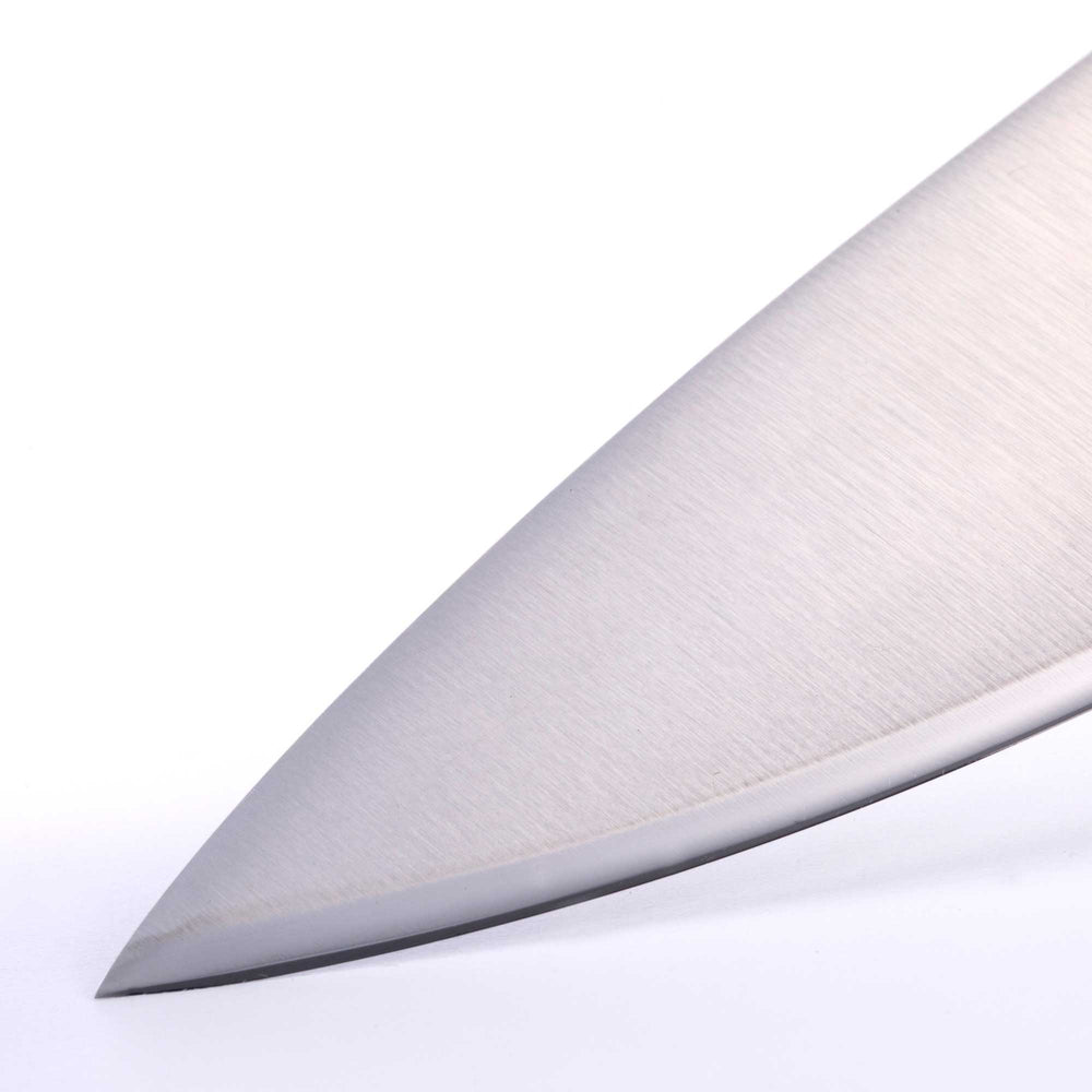 Close-up of the Messermeister Blacksmith 8-Inch Chef’s Knife tip, showcasing the precision-forged pointed blade, hammered blacksmith finish, and razor-sharp cutting edge designed for detailed slicing and prep work
