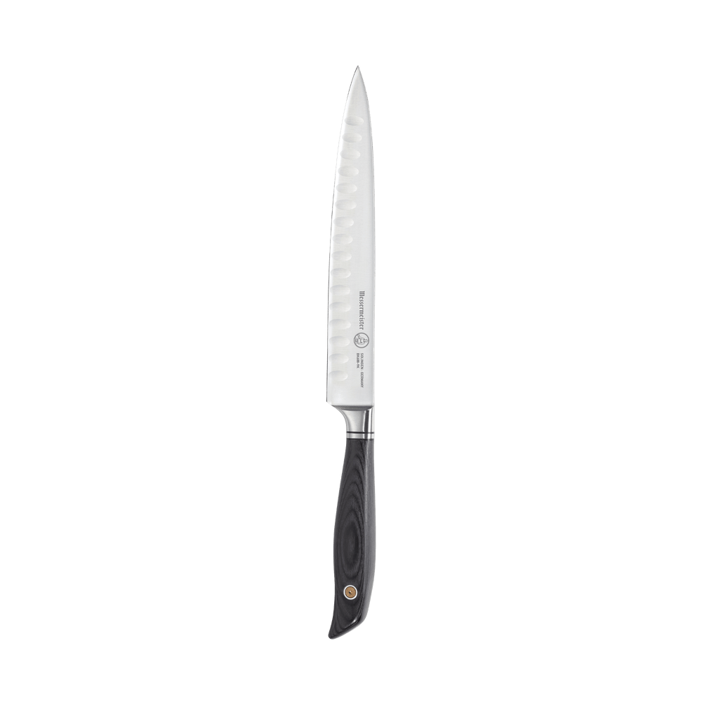 Messermeister Blacksmith 9-Inch Kullens Carving Knife featuring a long, narrow high-carbon stainless steel blade with kullens granton indentations and a hammered blacksmith finish, paired with an ergonomic ebony pakkawood handle for smooth, precise slicing of meats and roasts