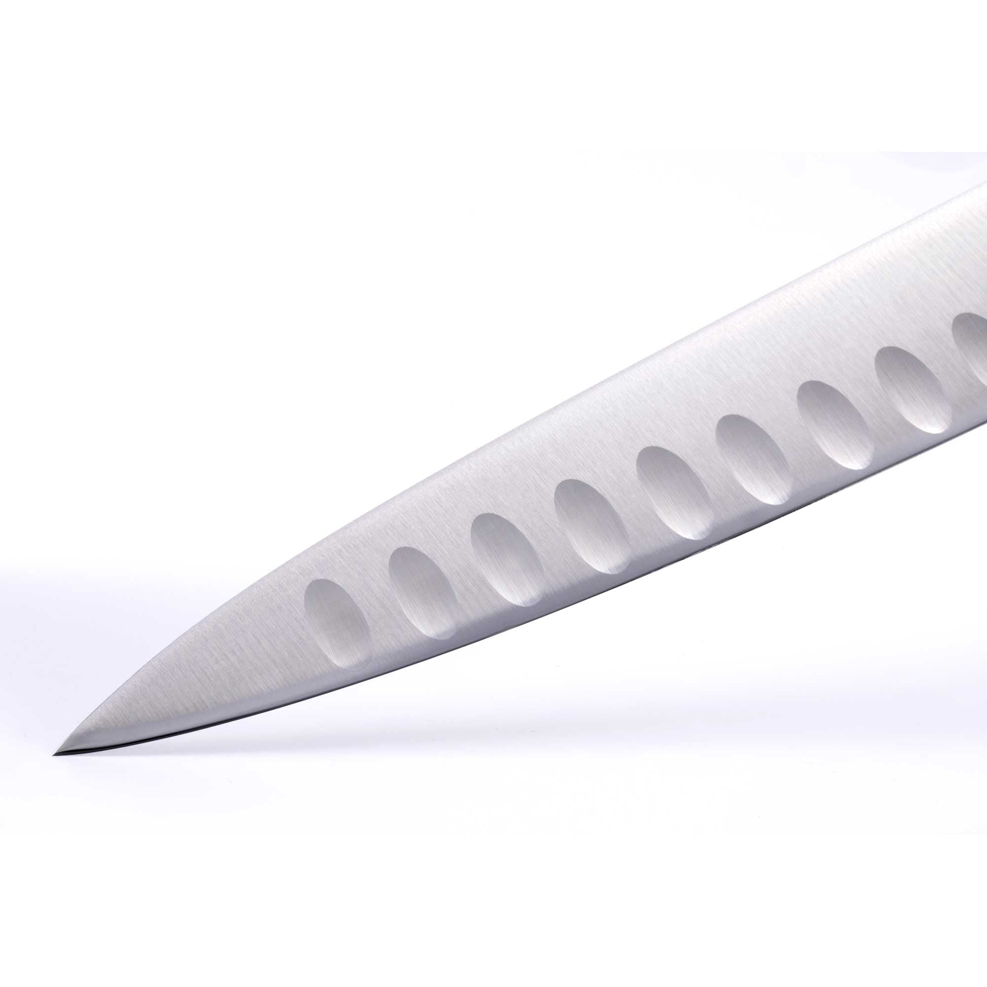 Close-up of the Messermeister Blacksmith 9-Inch Kullens Carving Knife blade, highlighting the hammered high-carbon stainless steel finish, kullens granton indentations, and long precision edge designed for smooth, even carving slices