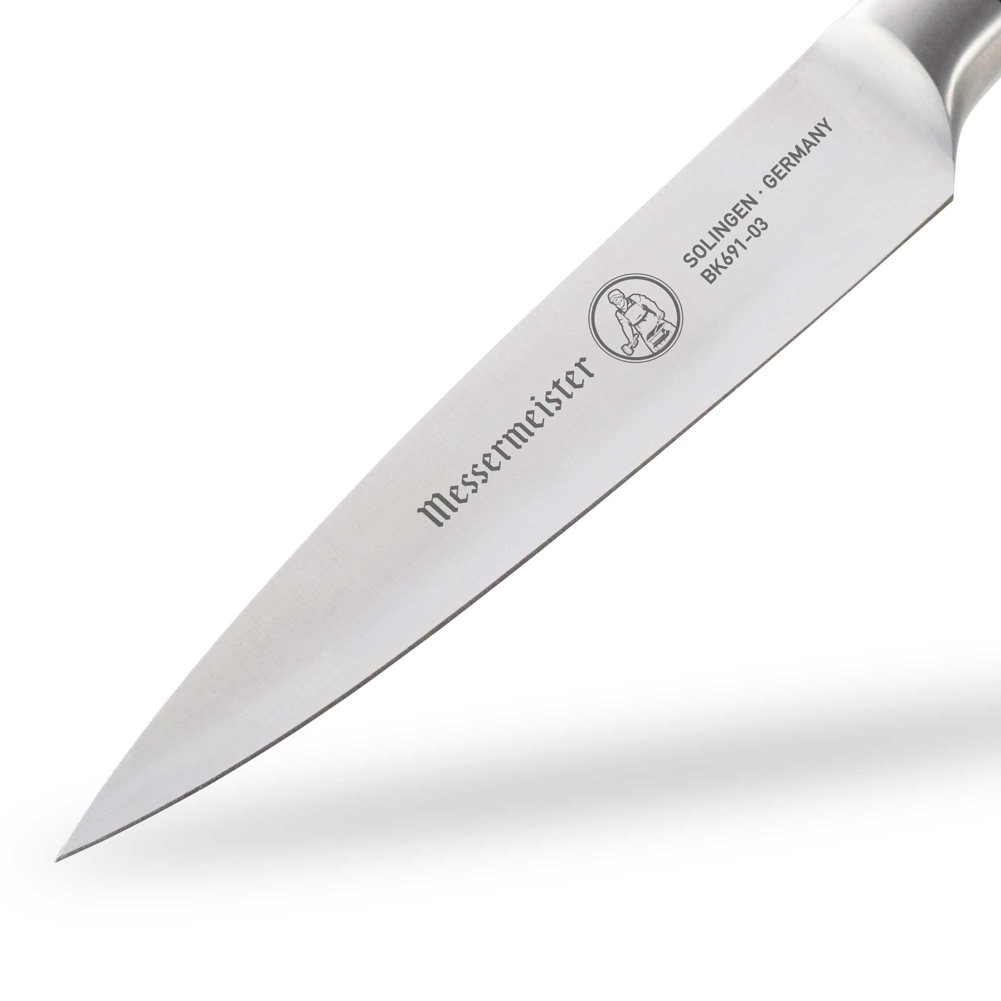 Close-up of the Messermeister Blacksmith 3.5-Inch Paring Knife blade, showcasing the hammered high-carbon stainless steel finish, fine precision edge, and pointed tip designed for intricate peeling and detail work