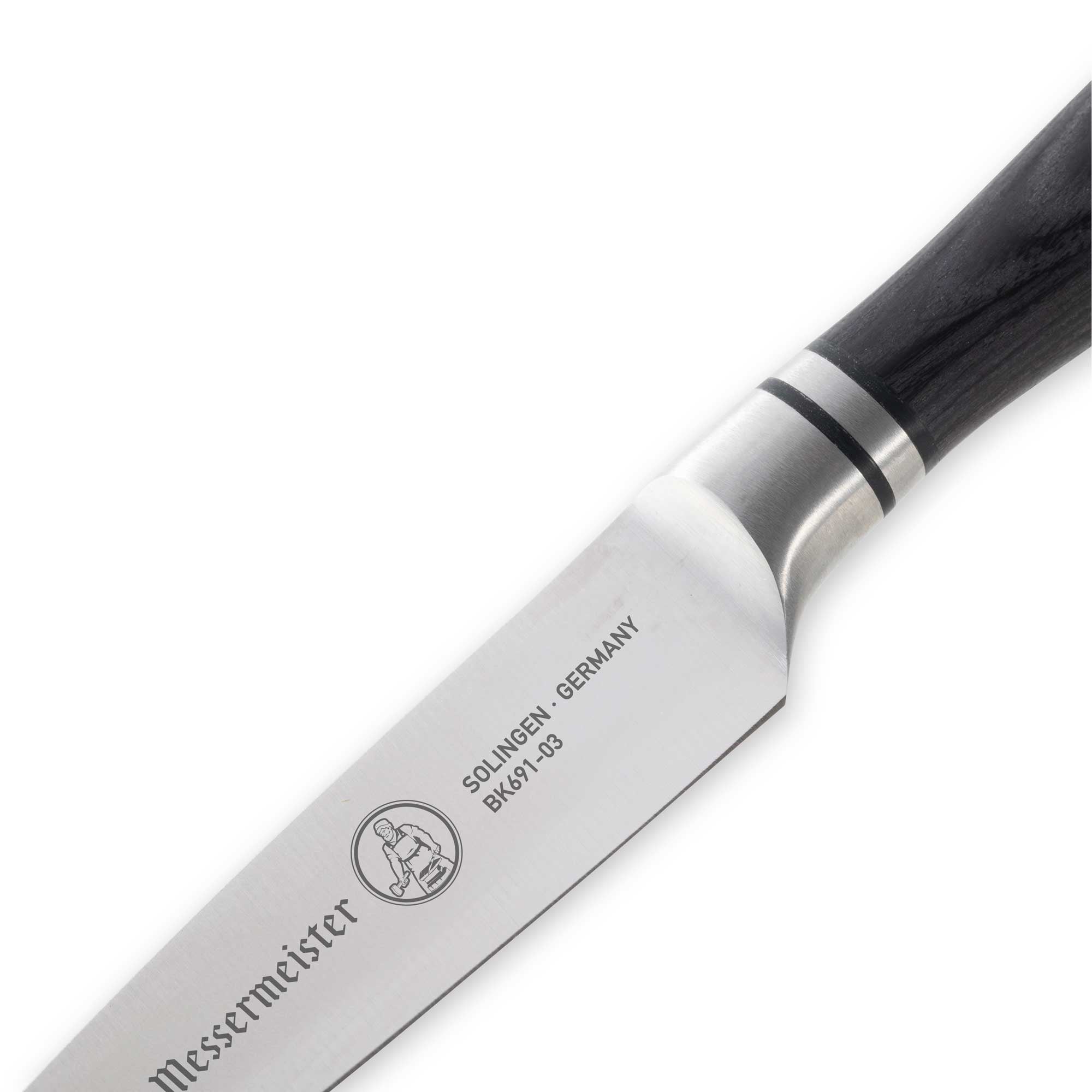 “Close-up of the heel of the Messermeister Blacksmith 3.5-Inch Paring Knife blade, highlighting the hammered high-carbon stainless steel finish and reinforced base of the edge for controlled slicing and precision cutting