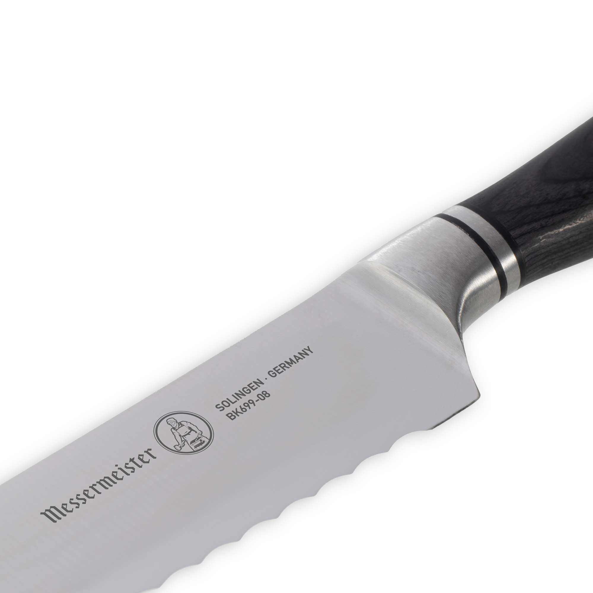 Messermeister Blacksmith Scalloped Slicing Knife 8.5 inch with stainless steel blade and ebony pakkawood handle close up on knife logo