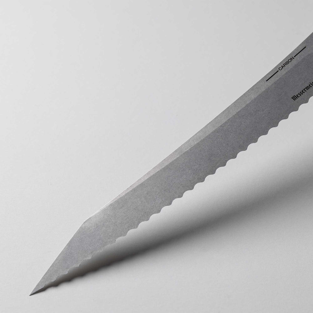 A close up view of the 9 inch Carbon Bread Knife blade with serration 