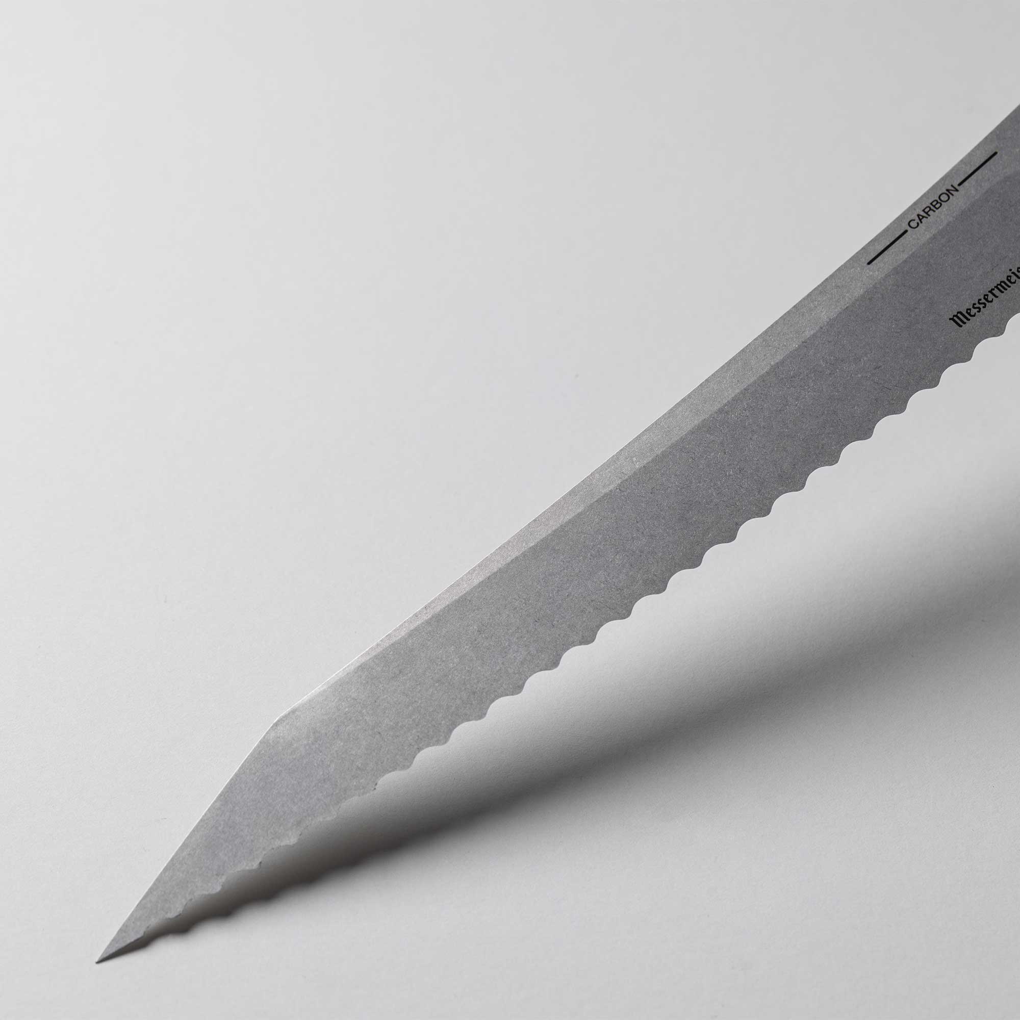 A close up view of the 9 inch Carbon Bread Knife blade with serration 
