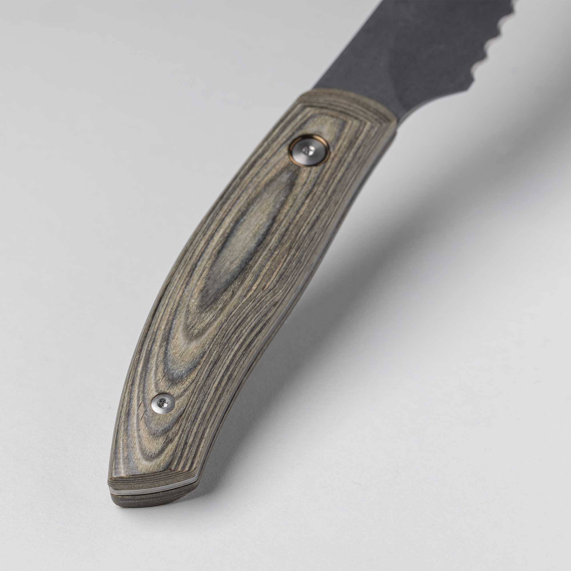 A close up of the 9 inch Carbon Bread Knife Spanish hardwood handle with 2 rivets that is stabilized with natural resins
