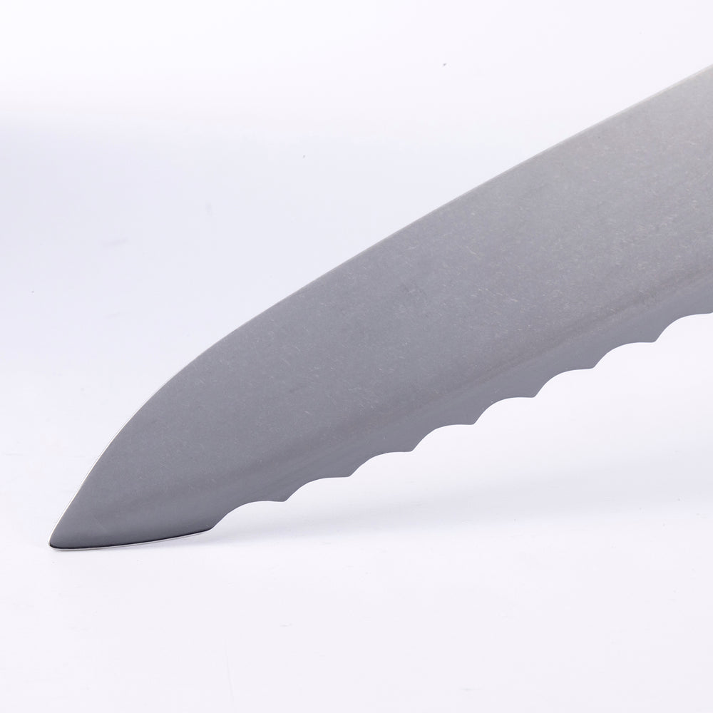 Close-up of Messermeister Custom scalloped bread knife tip highlighting serrated blade edge and steel finish