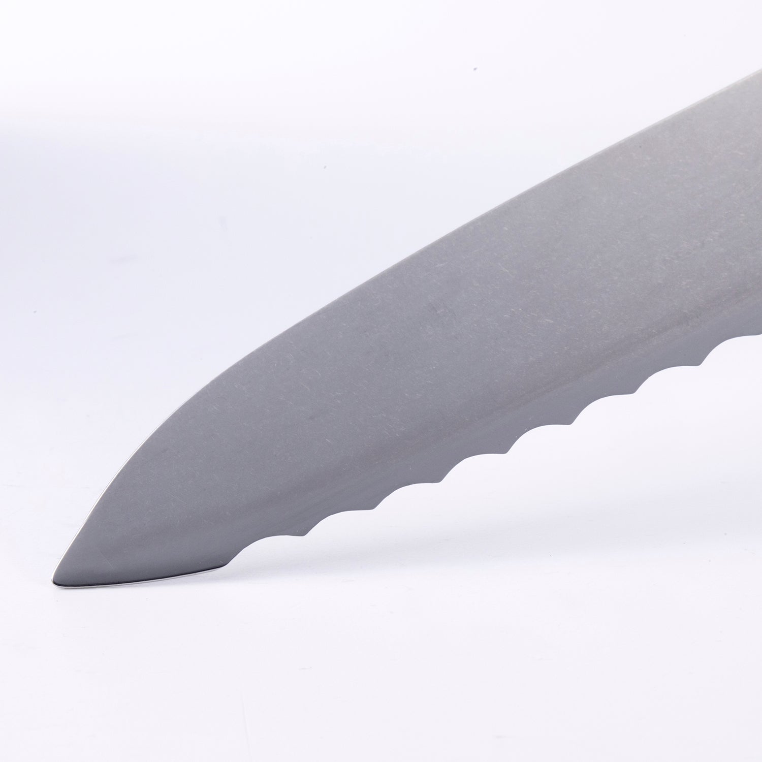 Close-up of Messermeister Custom scalloped bread knife tip highlighting serrated blade edge and steel finish