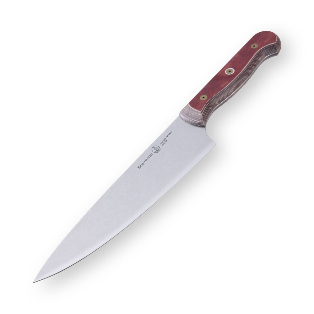 8-inch Messermeister Custom Red chef’s knife shown at a downward angle, featuring a polished stainless steel blade and a bold red ergonomic handle. The blade tapers to a sharp point, with the angle emphasizing its curve, edge refinement, and professional kitchen craftsmanship