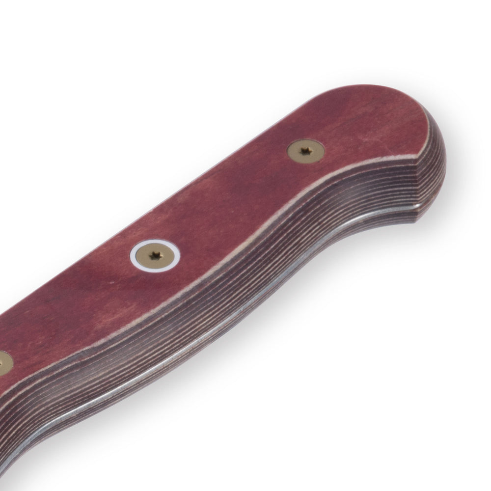 Close-up of red ergonomic handle on 8-inch Messermeister Custom Red chef’s knife, showing contoured grip texture and seamless steel bolster transition.
