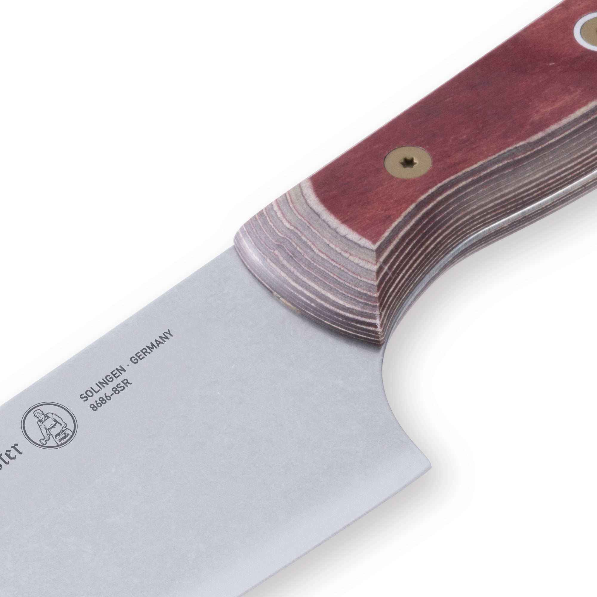 Close-up of the heel of 8-inch Messermeister Custom Red chef’s knife showing thick polished steel base meeting bright red handle clean grind solid build durable finish edge