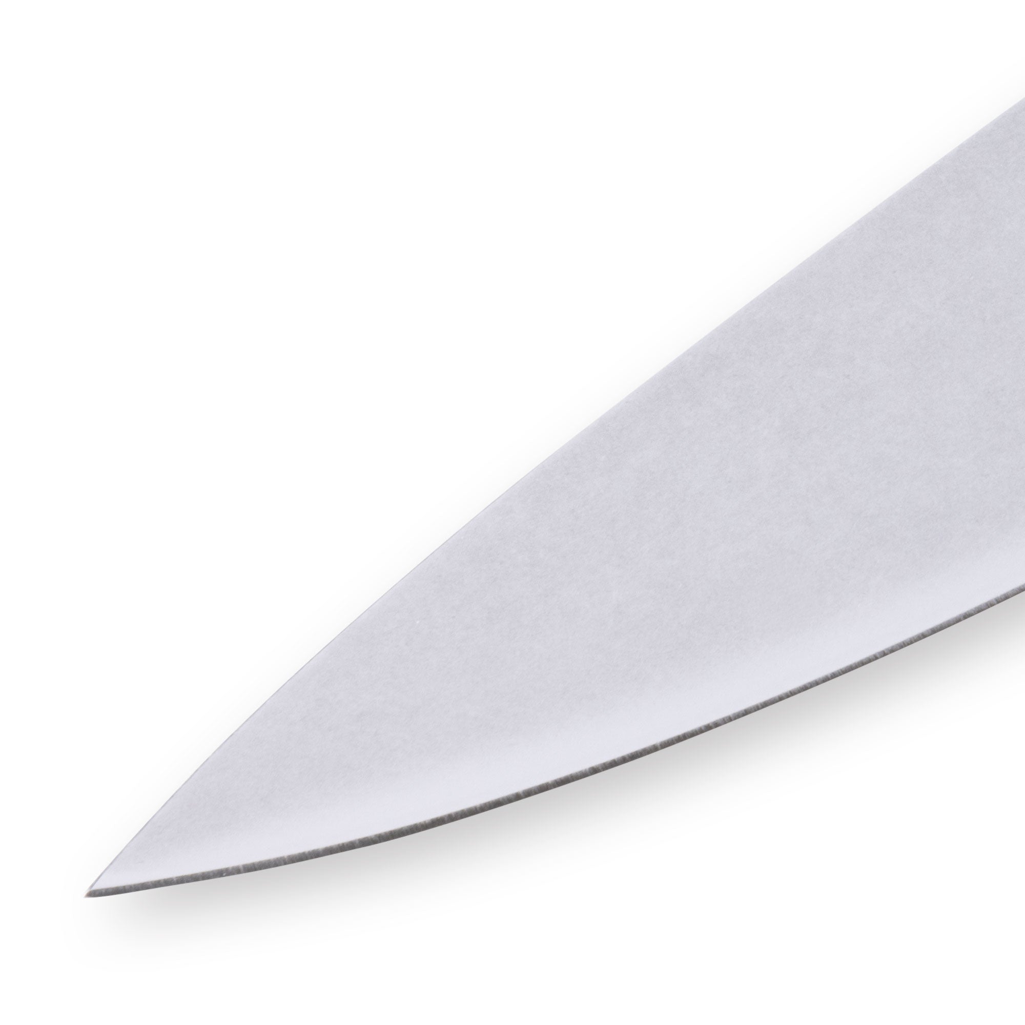Close-up of the tip of an 8-inch Messermeister Custom Red chef’s knife, highlighting the fine, sharp point of the polished stainless steel blade tapering to a precise edge