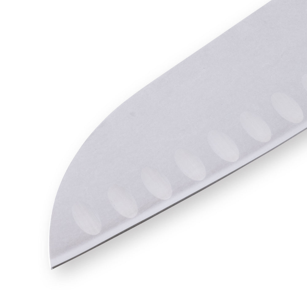 Close-up of the tip of a 7-inch Messermeister Custom Red Kullens Santoku knife, showing the polished stainless steel blade tapering to a fine point with granton edge detail