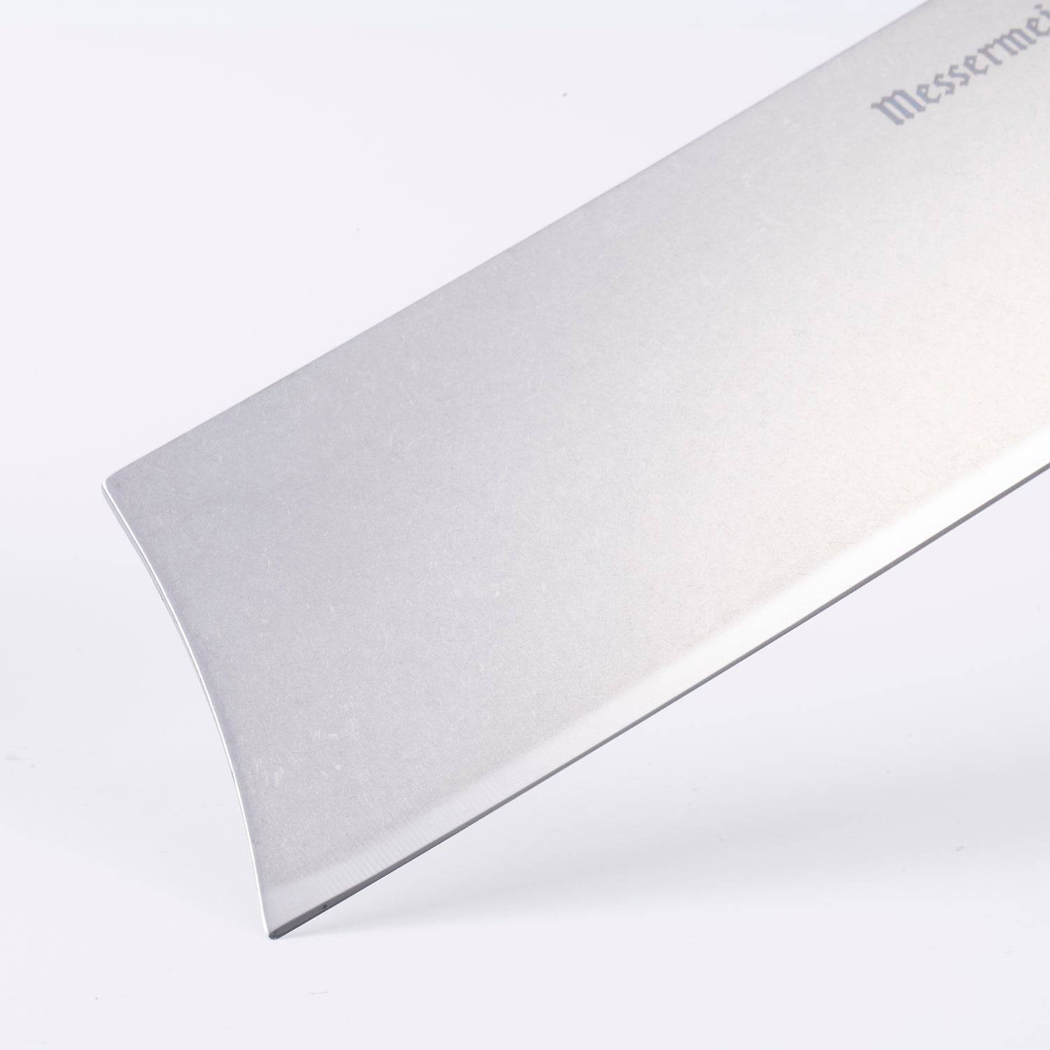 Close-up of the squared tip of a 6.5-inch Messermeister Custom Red Nakiri knife, showing the straight edge and polished stainless steel blade finish
