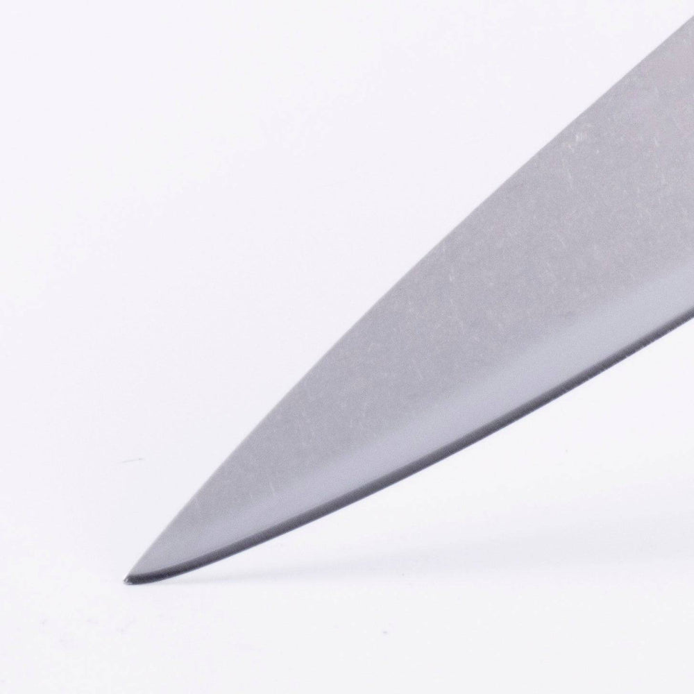 Close-up of the pointed tip of the Messermeister Custom Red 3.5-inch Paring Knife, showcasing the fine stainless steel edge designed for precise peeling and trimming