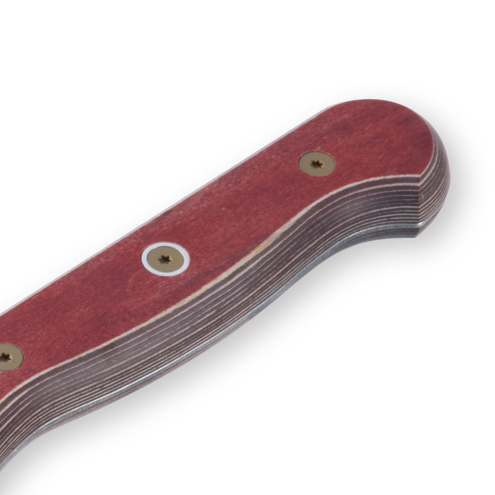 Close-up of the red ergonomic handle on an 8-inch Messermeister Custom Red scalloped offset knife, showing its smooth contoured grip and seamless transition to the offset blade