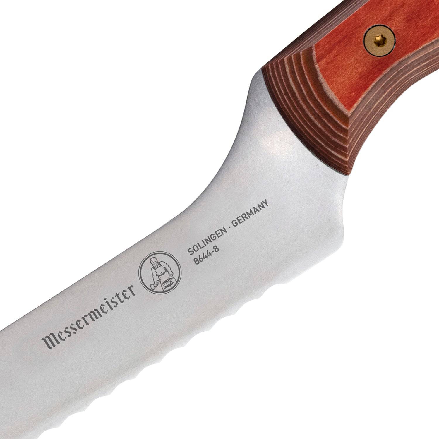 Close-up of the heel of an 8-inch Messermeister Custom Red scalloped offset knife, showing the base of the serrated stainless steel blade meeting the red ergonomic handle