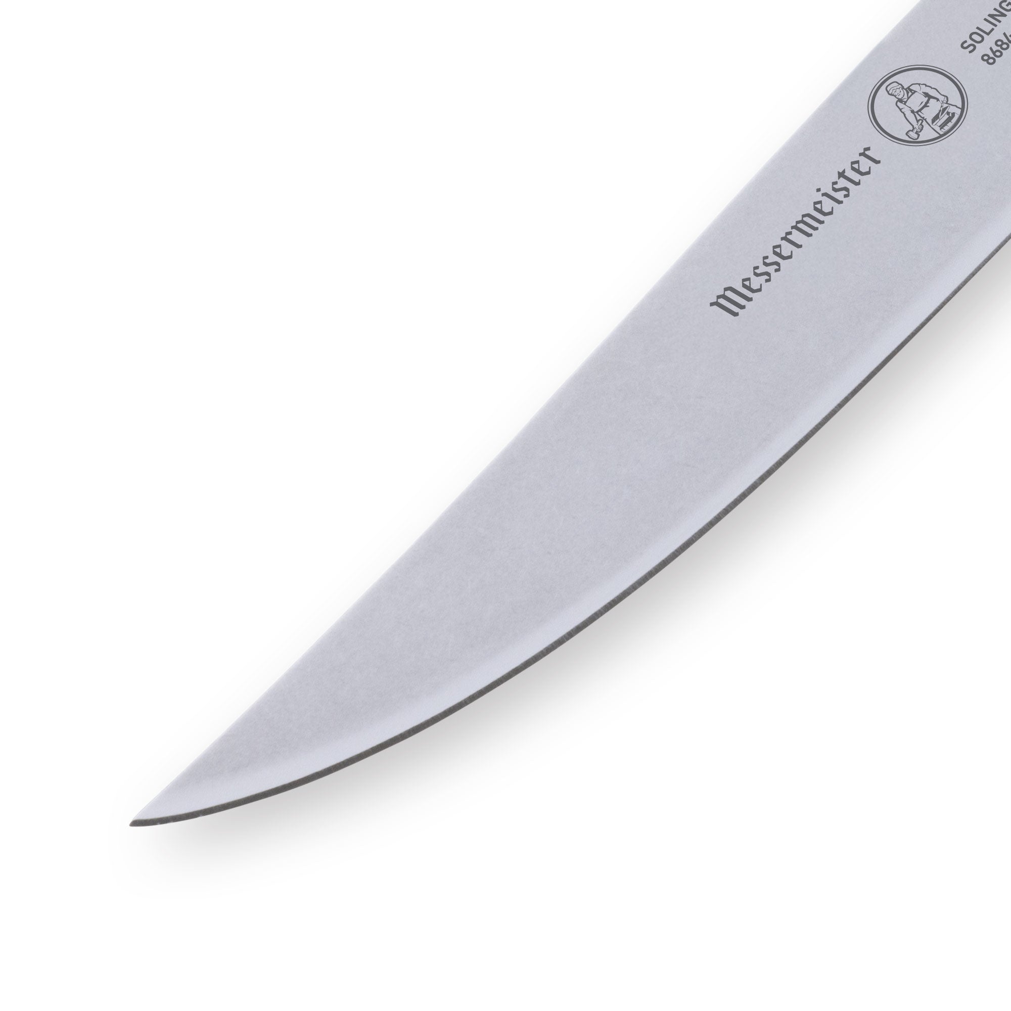 Close-up of the serrated tip of the Messermeister Custom Red Steak Knife, highlighting the precision stainless steel teeth designed for effortless meat slicing