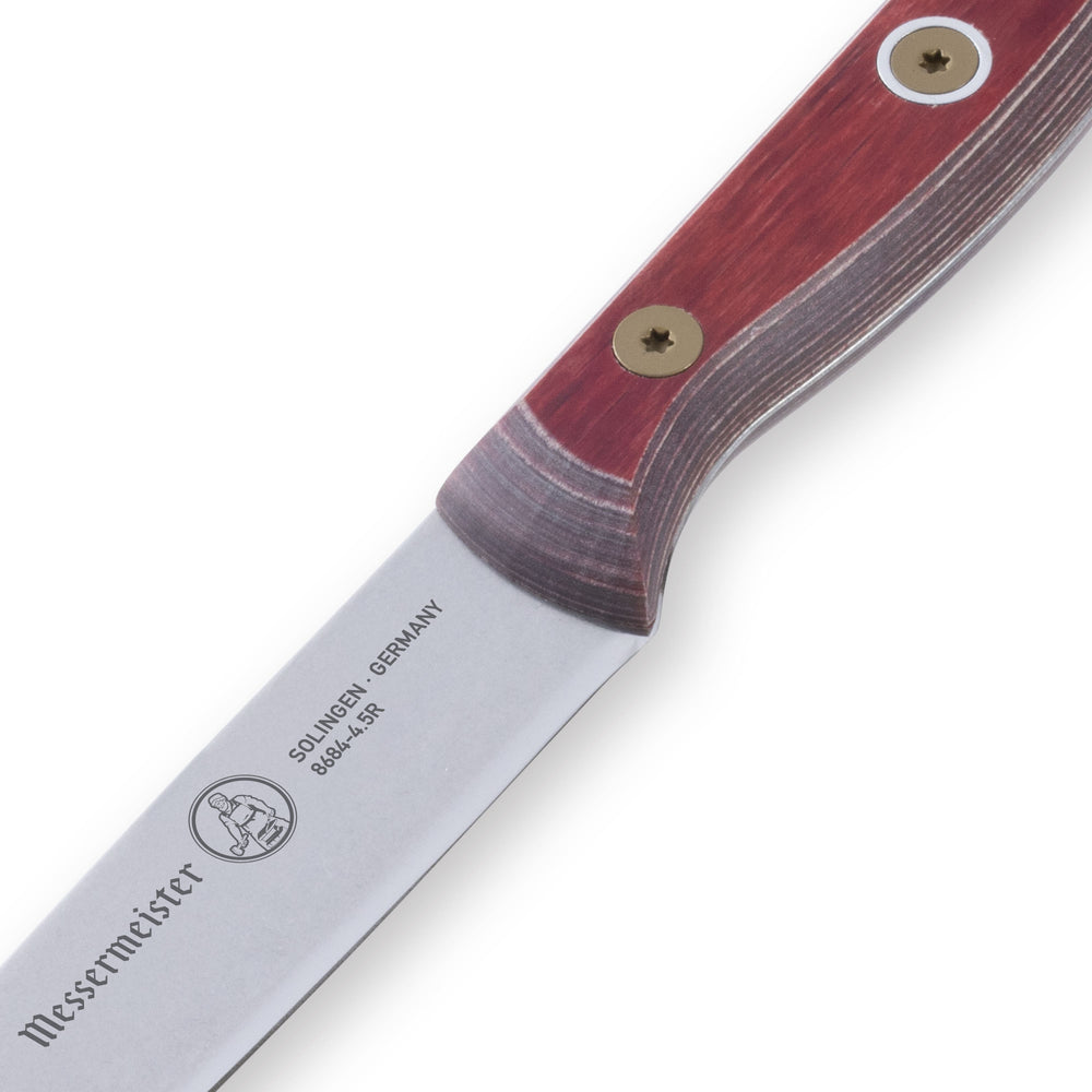 Close-up of the Messermeister Custom Red Steak Knife logo detail on the handle, highlighting branding, textured red grip, and premium craftsmanship finish