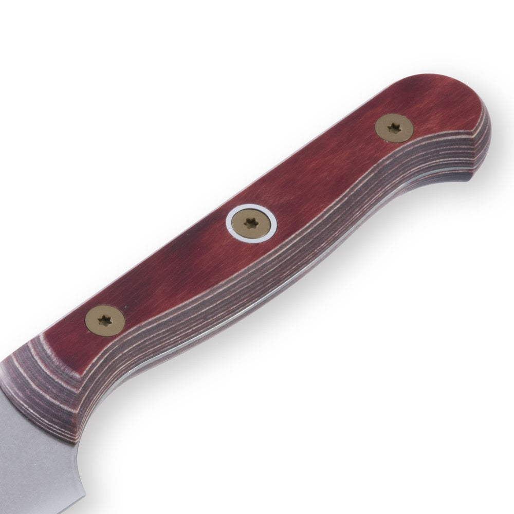 Close-up of the red ergonomic handle of a 6-inch Messermeister Custom Red utility knife, highlighting its smooth contours, secure grip, and polished finish