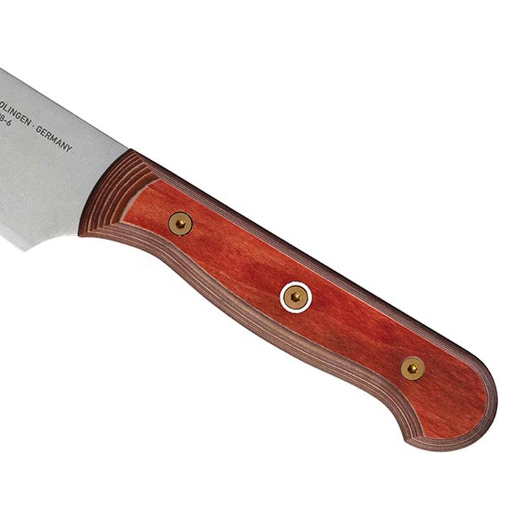 Close-up of the red ergonomic handle of a 6-inch Messermeister Custom Red utility knife, highlighting its smooth contours, secure grip, and polished finish