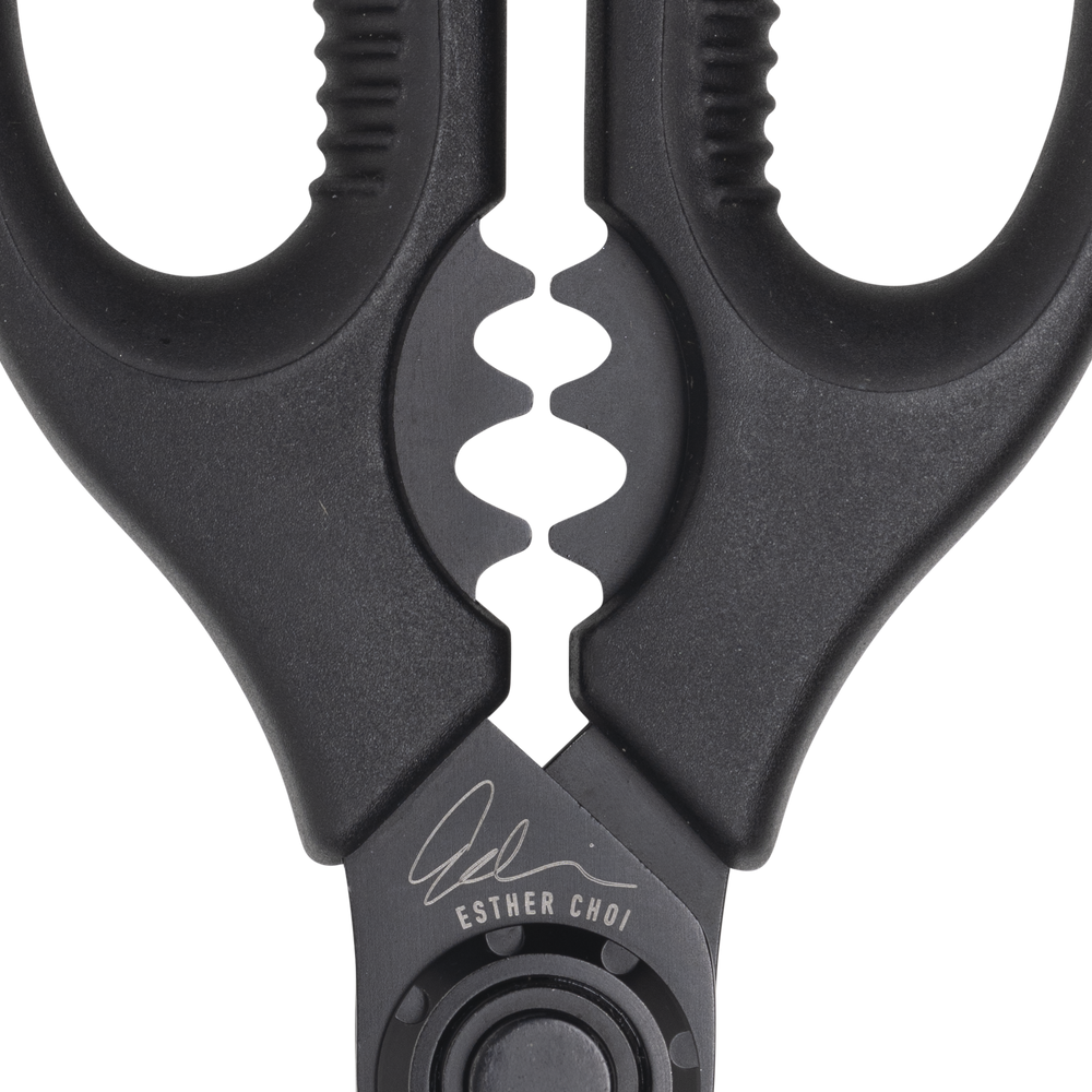 Esther Choi 7-inch push button take-apart precision shears close-up highlighting the bone notch detail, showing stainless steel blades and precision cutting edge designed for trimming poultry and seafood in kitchen prep