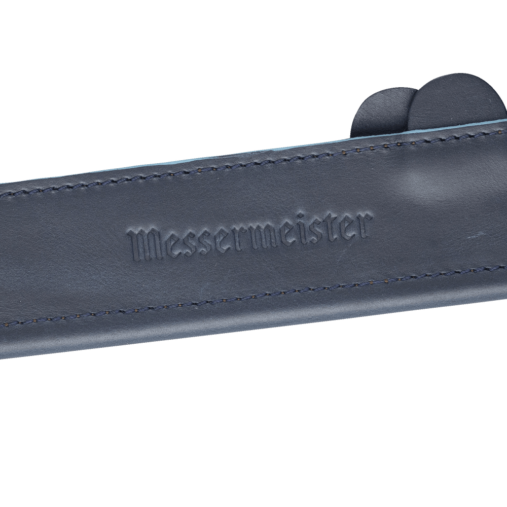 Messermeister 6.5 inch Midnight Navy Leather Magnetic Edge Guard Soft Rubber Magnets For a Gentle Grip close up on logo 