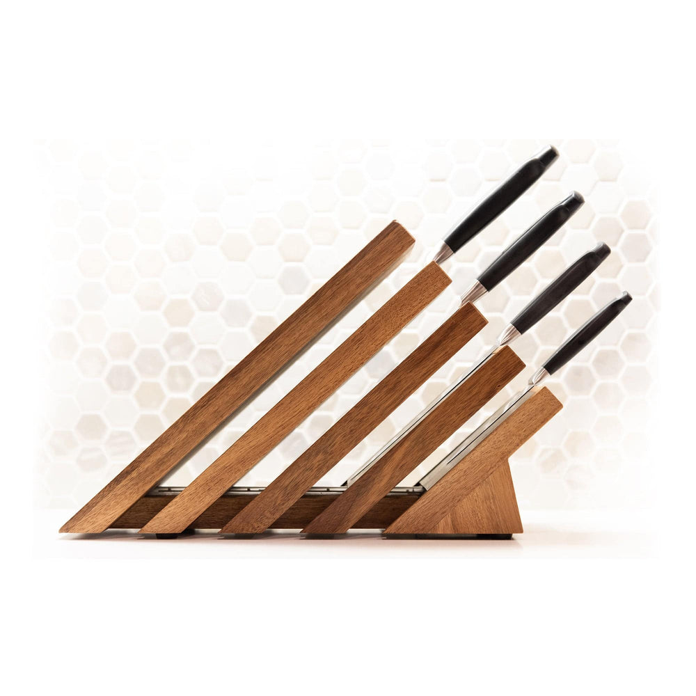 Messermeister Next Level Magnetic Knife Block with a single black handled knife stored on each of the 4 slots. Block is showing the side view with handles to the right. On an octagon background that fades out to white.