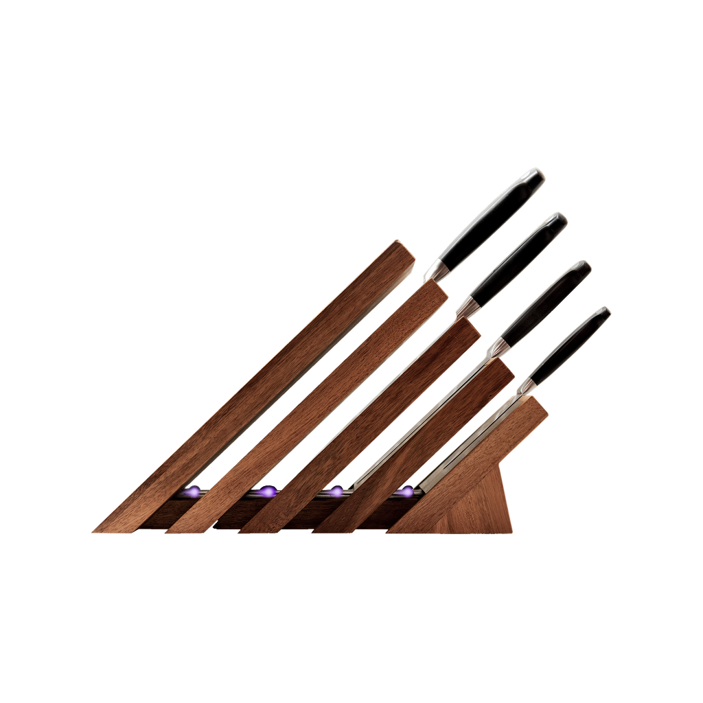 Messermeister Next Level Magnetic Knife Block and UV light with a single black handled knife stored on each of the 4 slots. Block is showing the side view with handles to the right.