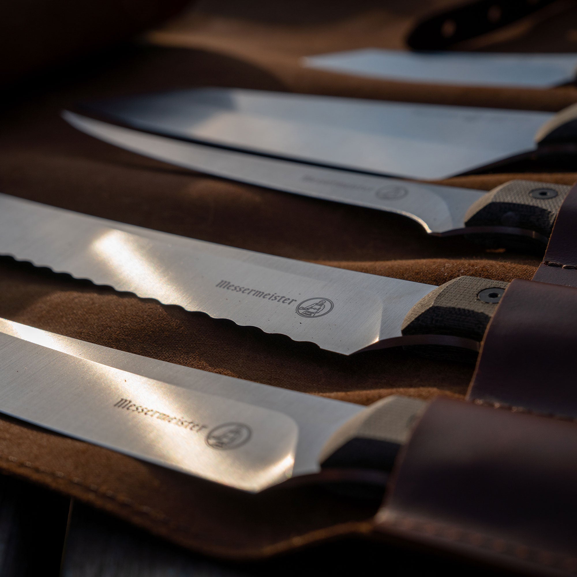 closeup of overland knives in a leather knife roll