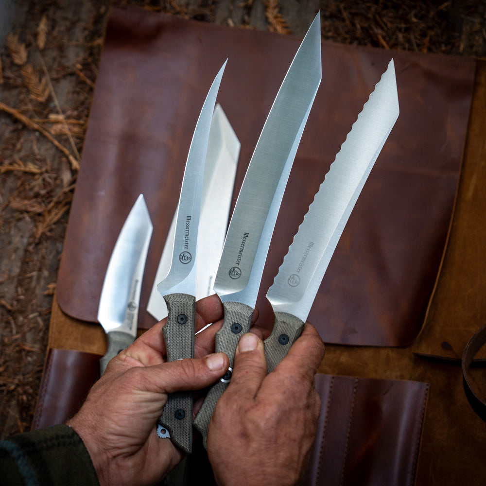 overland filet knife, slicer, and scalloped slicer being held above a leather knife roll